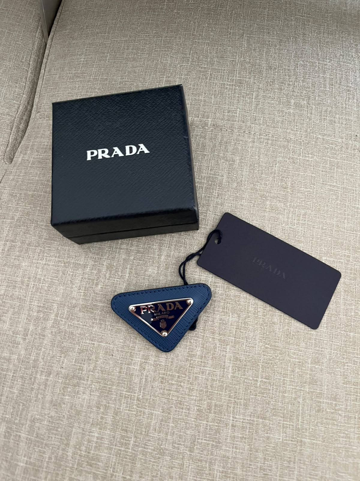 Prada spilla triangle logo