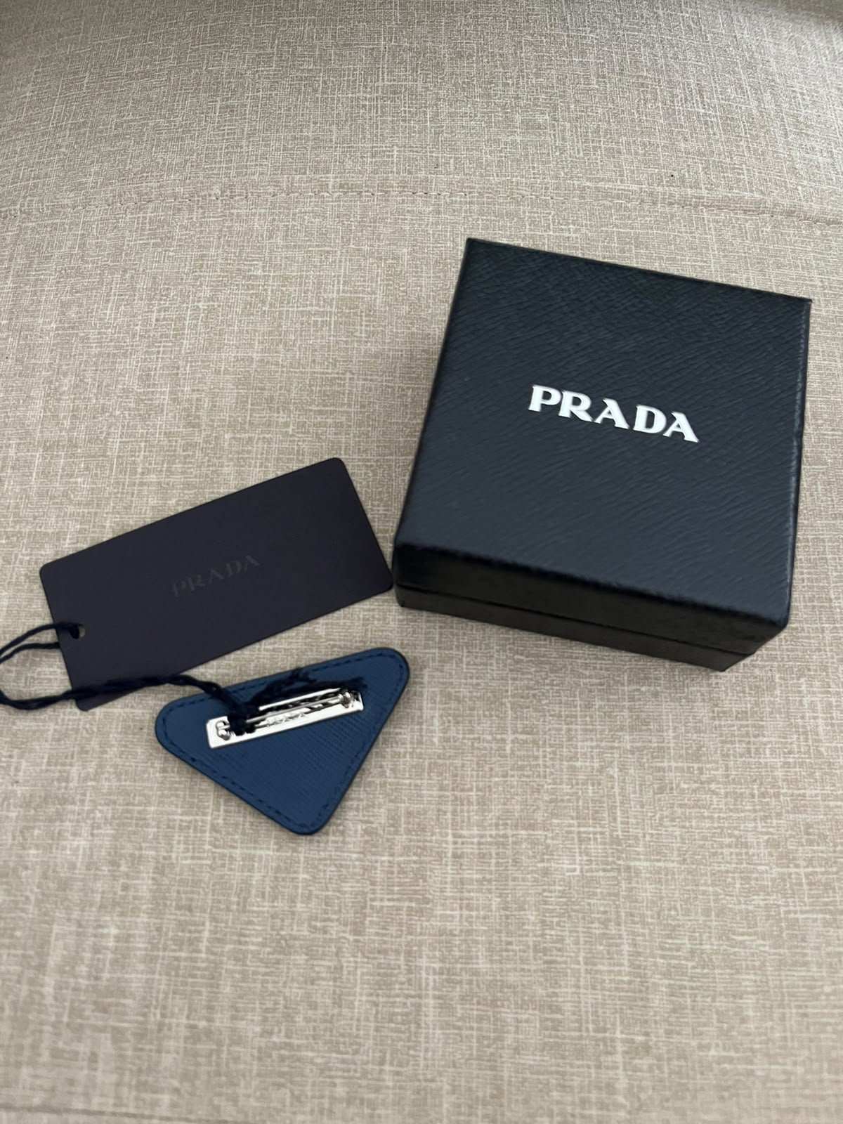 Prada spilla triangle logo