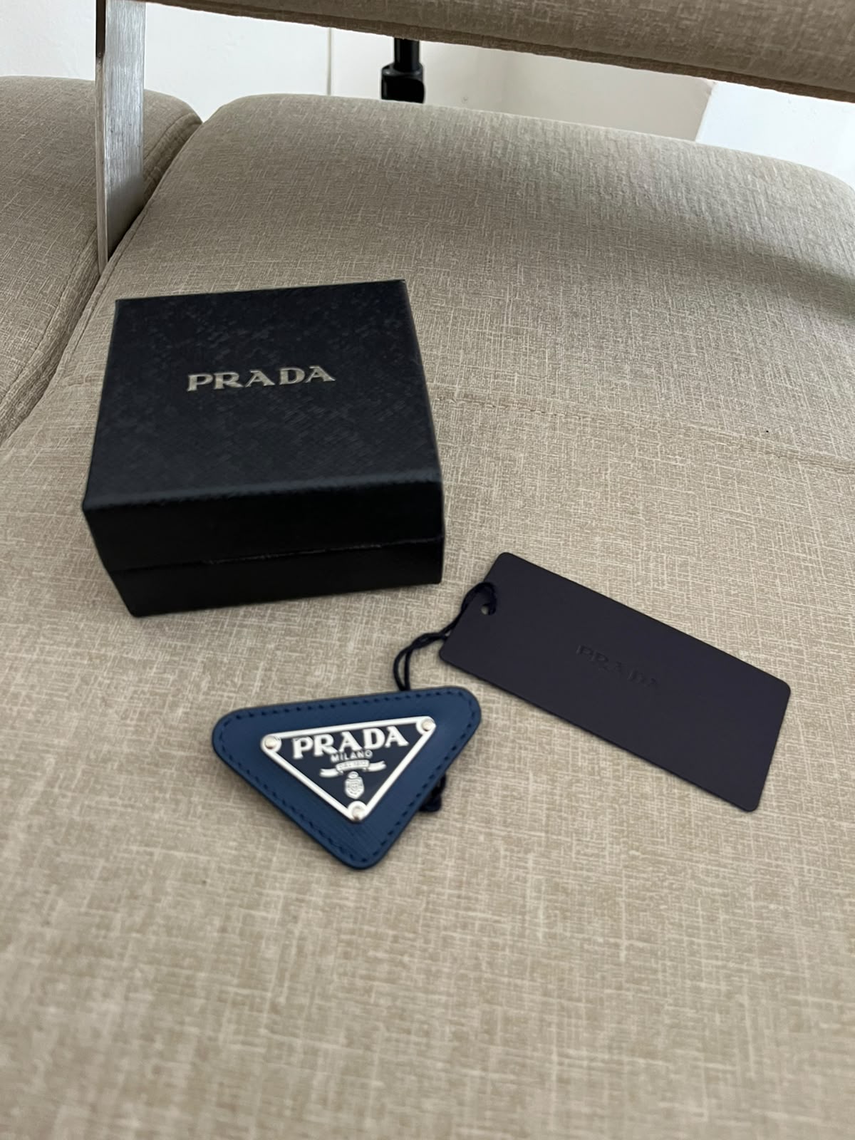 Prada spilla triangle logo
